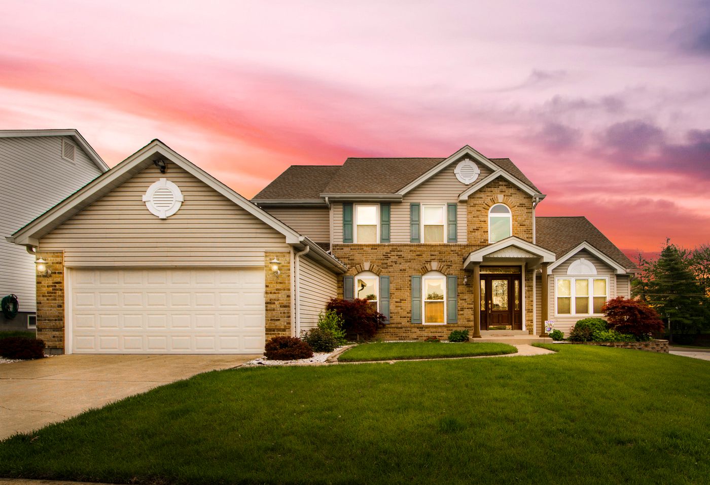 Well-kept two-story suburban home at sunset